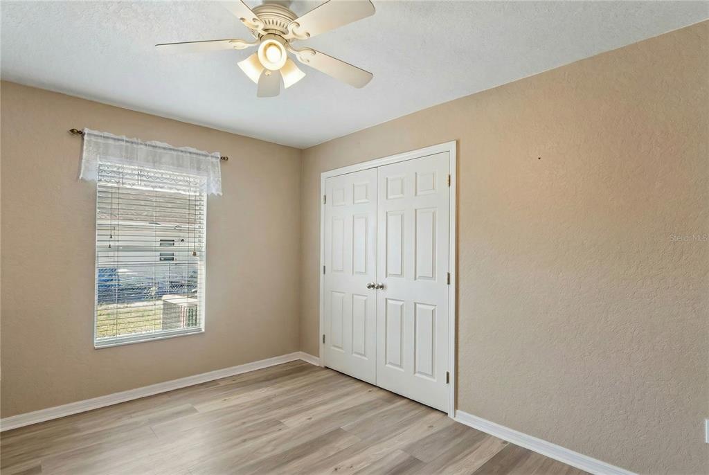 10318 Gifford Drive Spring Hill, FL 34608 - Photo 40 of 57 a view of an empty room with window and wooden floor