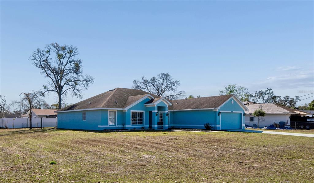 10318 Gifford Drive Spring Hill, FL 34608 - Photo 53 of 57 a front view of house with yard and trees in the background