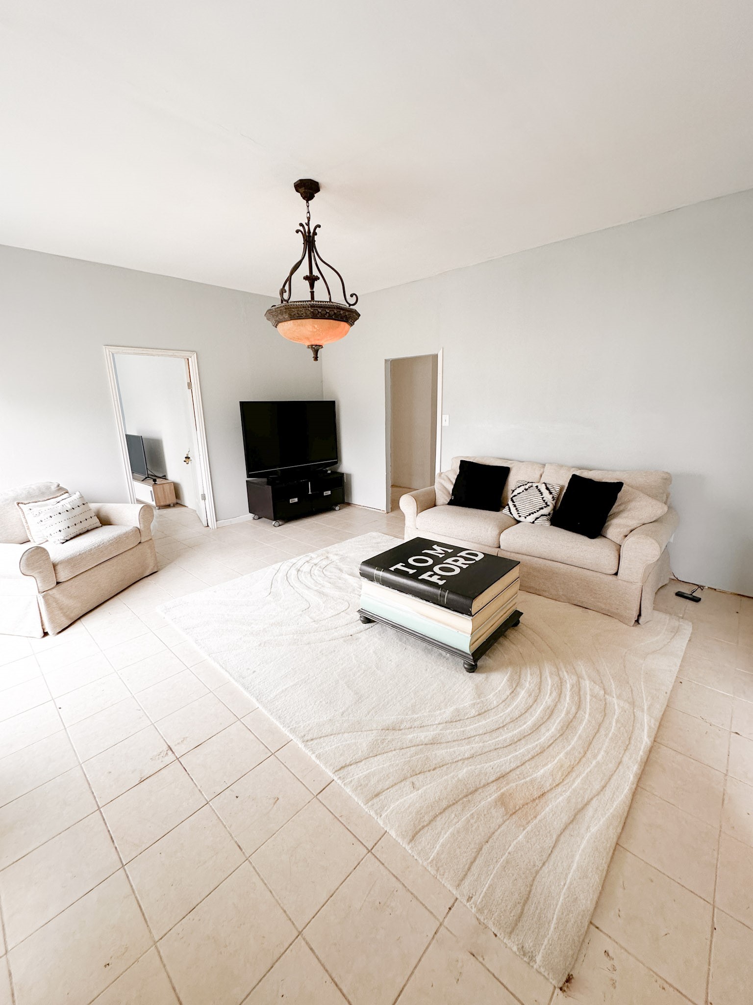 638 Kelly Lane Angleton, TX 77515 - Photo 4 of 21 a bedroom with a bed and a chandelier