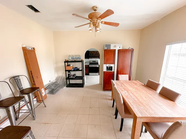 a view of a dining room with furniture and a chandelier