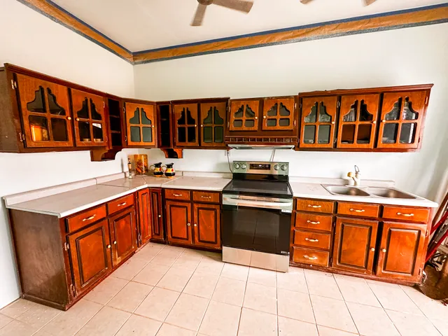 a kitchen with stainless steel appliances granite countertop a stove and cabinets