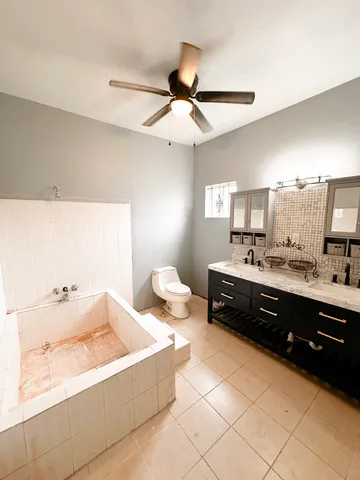 a spacious bathroom with a tub sink and toilet