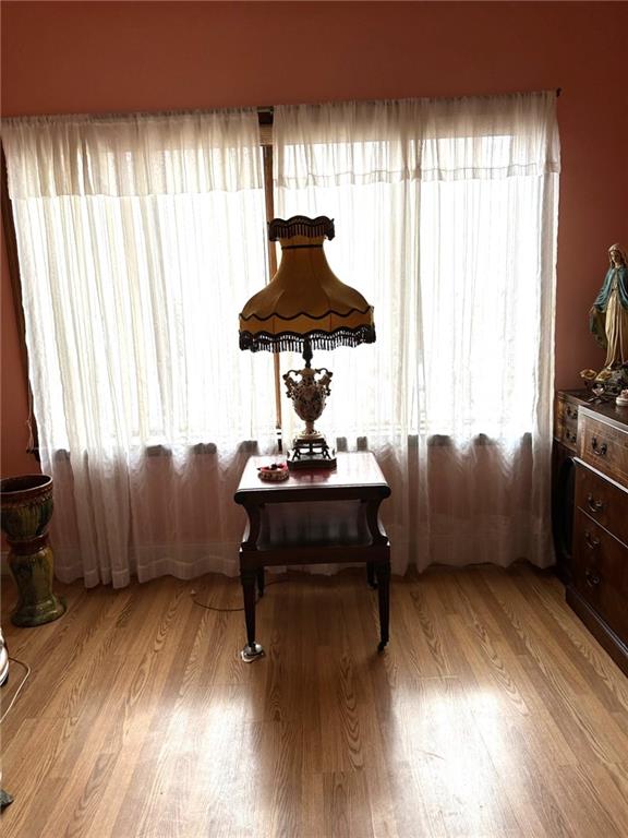 1334 66th Street Brooklyn, NY 11219 - Photo 11 of 15 a living room with furniture and a wooden floor
