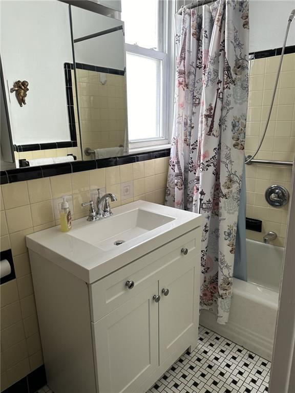 1334 66th Street Brooklyn, NY 11219 - Photo 12 of 15 a bathroom with a sink a toilet and shower