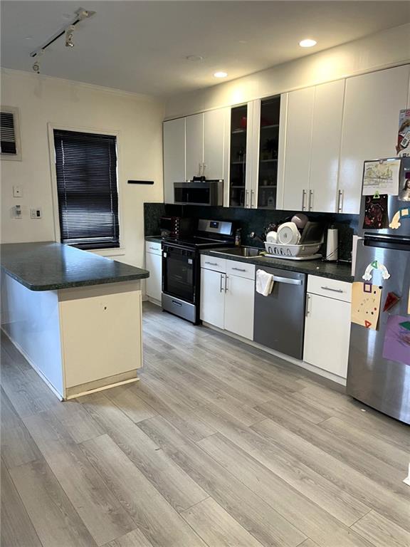 1334 66th Street Brooklyn, NY 11219 - Photo 3 of 15 a kitchen with stainless steel appliances kitchen island granite countertop a stove a sink and a microwave