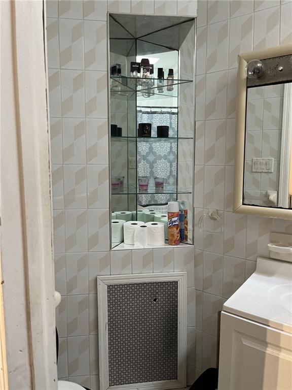 1334 66th Street Brooklyn, NY 11219 - Photo 6 of 15 a bathroom with a sink and a mirror