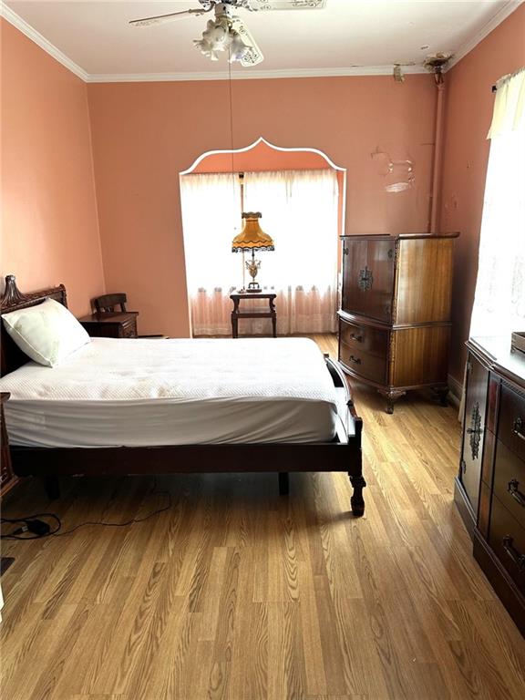 1334 66th Street Brooklyn, NY 11219 - Photo 9 of 15 a bedroom with a bed and wooden floor