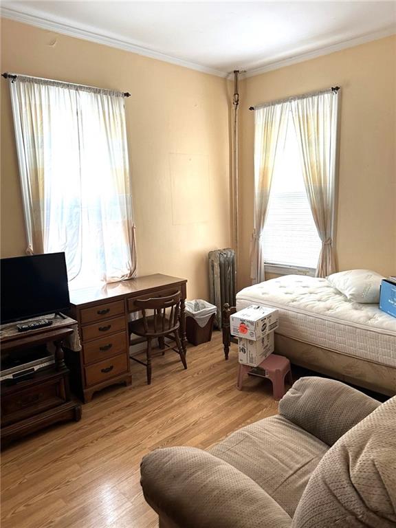 1334 66th Street Brooklyn, NY 11219 - Photo 10 of 15 a bedroom with a bed and wooden floor