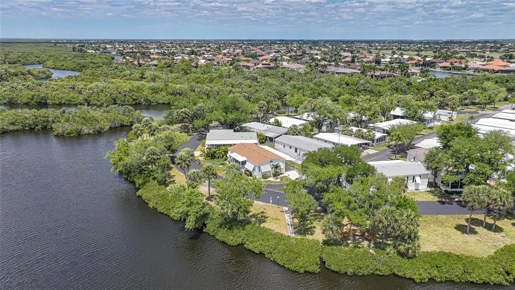 10303 Burnt Store Road, Unit 143 Punta Gorda, FL 33950 - Photo 33 of 42 an aerial view of a house with a yard and lake view