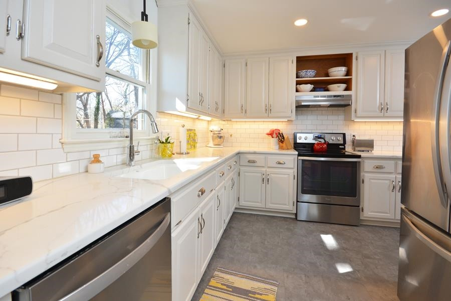 108 Rother Lane Durham, NC 27707 - Photo 11 of 34 a kitchen with a sink a stove and cabinets