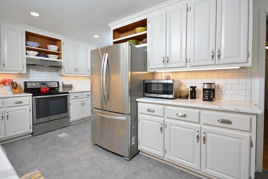 108 Rother Lane Durham, NC 27707 - Photo 12 of 34 a kitchen with cabinets and stainless steel appliances