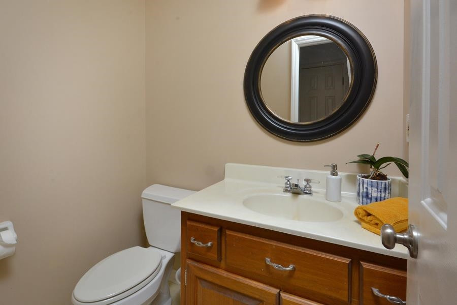 108 Rother Lane Durham, NC 27707 - Photo 18 of 34 a bathroom with a sink mirror vanity and toilet