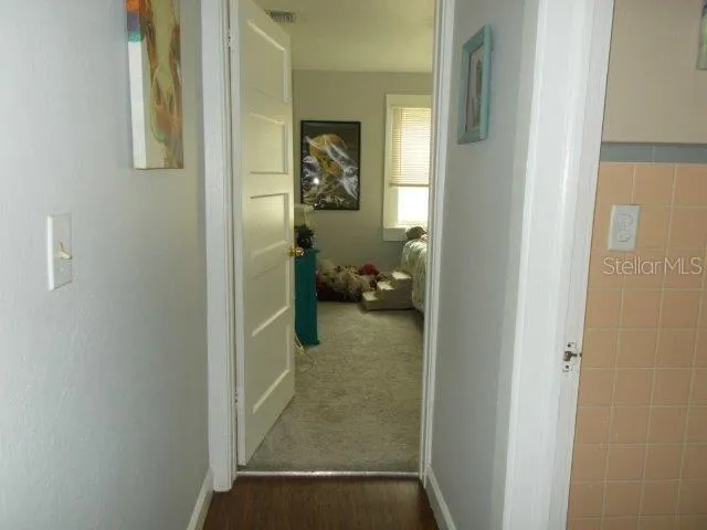 a view of a hallway view with wooden floor and staircase