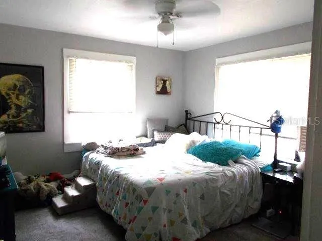 a bedroom with a bed and a window