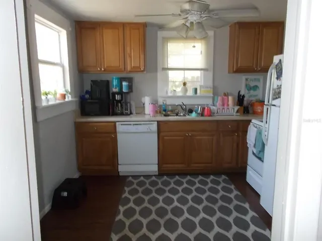 a view of a house with backyard and sitting area