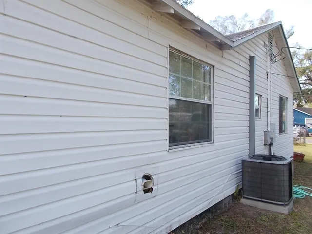 a car parked in front of a white house