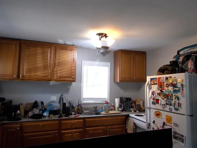 a view of door in front of house with wooden fence