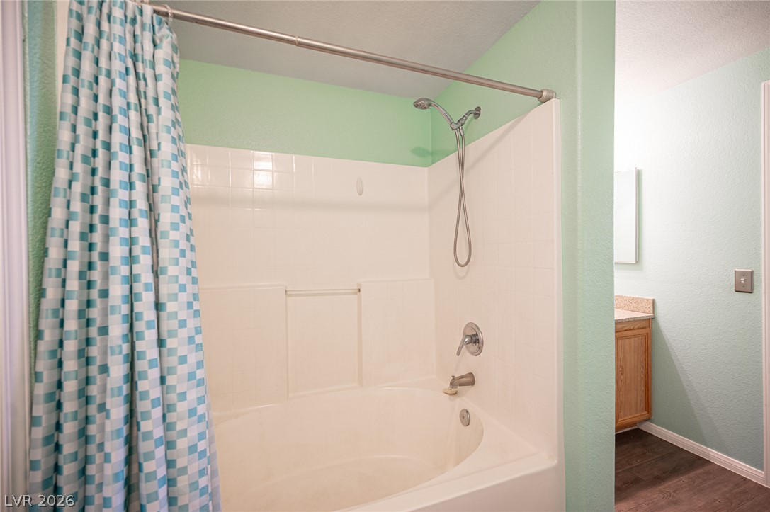 10550 West Alexander Road, Unit 2014 Las Vegas, NV 89129 - Photo 27 of 35 A well-maintained tub and shower combination with a bright shower curtain awaits.