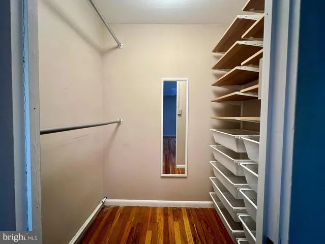 a view of walk in closet with empty racks