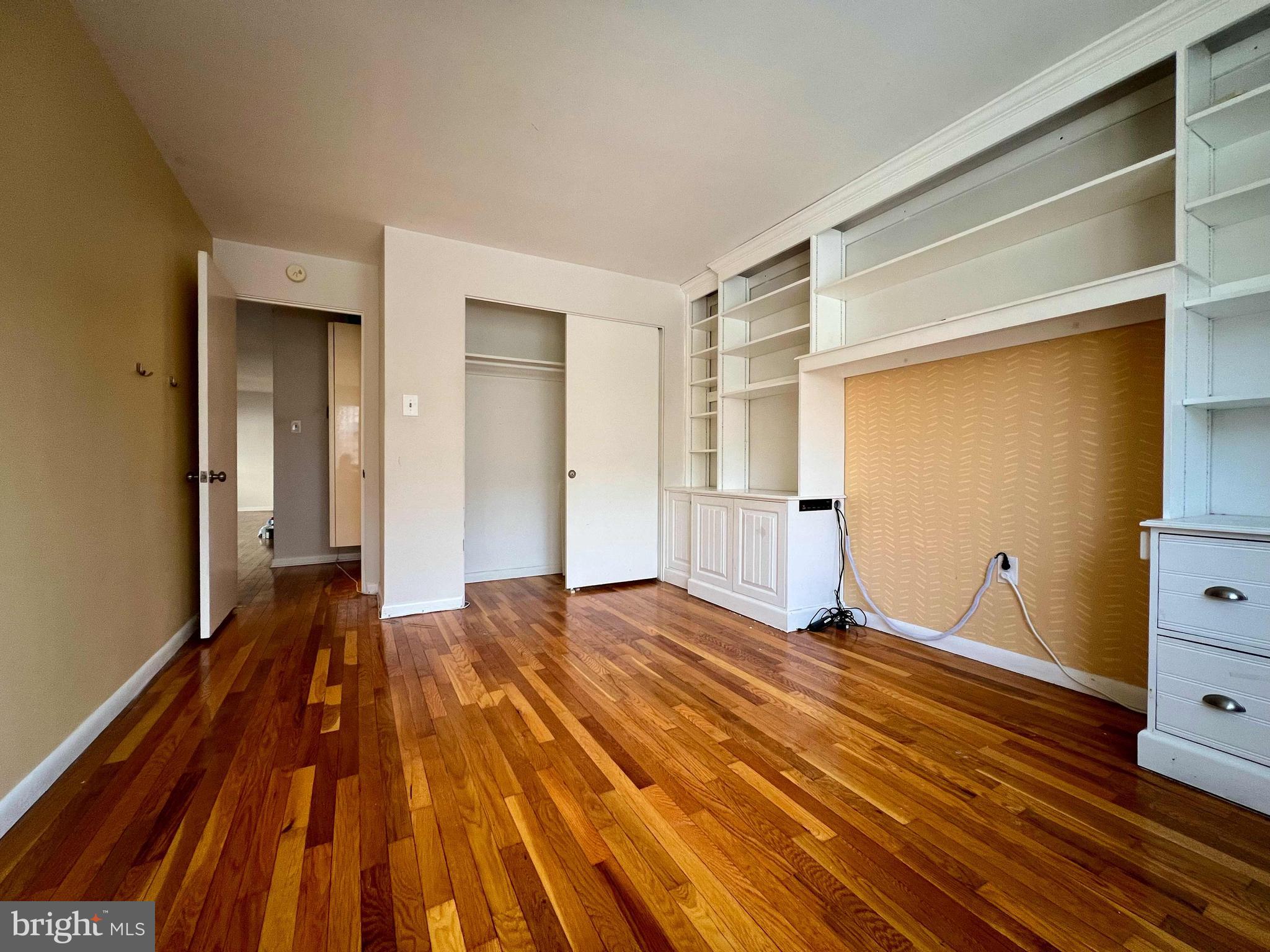 175 West King Street, Unit 107 Malvern, PA 19355 - Photo 18 of 27 a bedroom with a bed and wooden floor