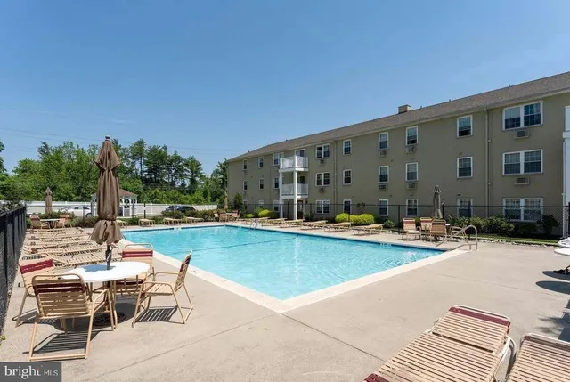 a view of swimming pool with outdoor seating and plants