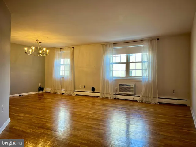 an empty room with piano and wooden floor