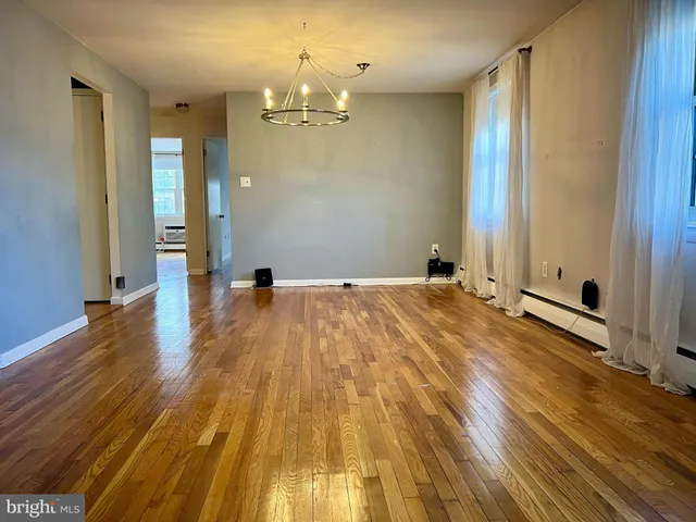 a view of a room with wooden floor