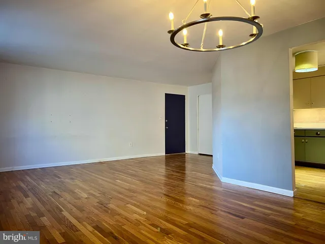a view of an empty room and wooden floor