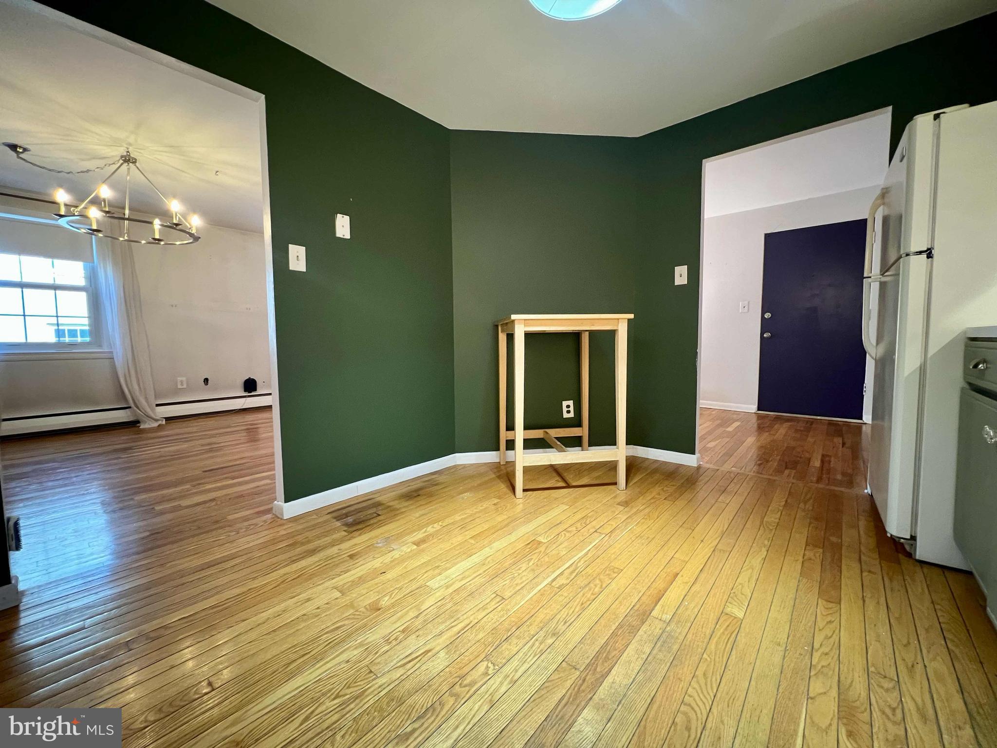 175 West King Street, Unit 107 Malvern, PA 19355 - Photo 10 of 27 a view of an empty room with wooden floor