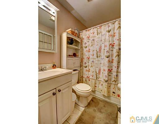 22 Sanders Road Edison, NJ 08817 - Photo 14 of 25 a bathroom with a sink toilet and shower