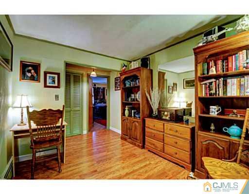 22 Sanders Road Edison, NJ 08817 - Photo 16 of 25 a living room with furniture and a flat screen tv