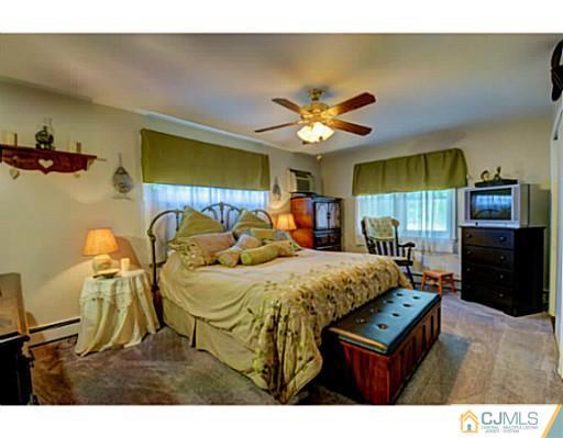22 Sanders Road Edison, NJ 08817 - Photo 17 of 25 a bed room with a bed and a television