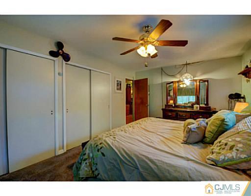 22 Sanders Road Edison, NJ 08817 - Photo 18 of 25 a bedroom with a bed and a chandelier
