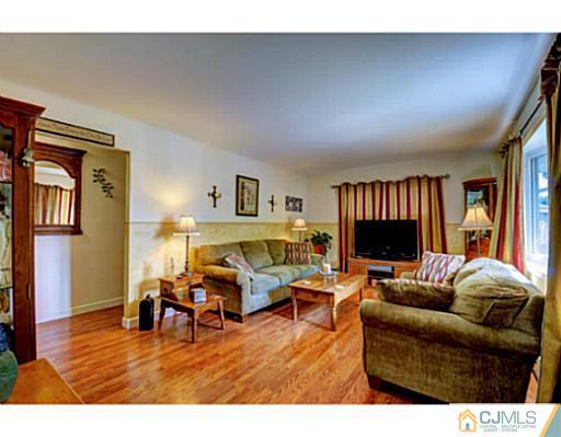 22 Sanders Road Edison, NJ 08817 - Photo 3 of 25 a living room with furniture and a flat screen tv