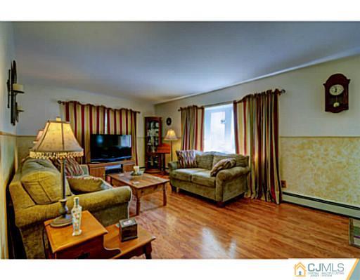 22 Sanders Road Edison, NJ 08817 - Photo 21 of 25 a living room with furniture and a flat screen tv