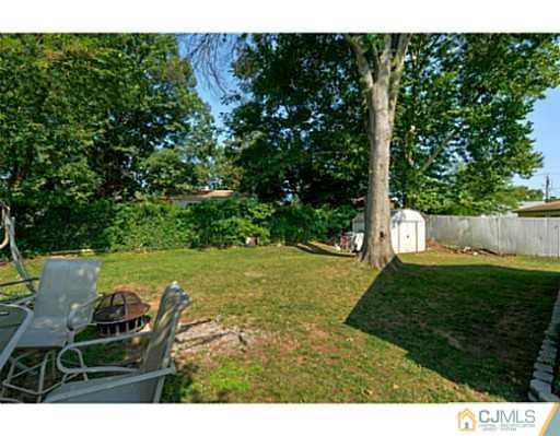 22 Sanders Road Edison, NJ 08817 - Photo 22 of 25 a view of a chair and table on the green field