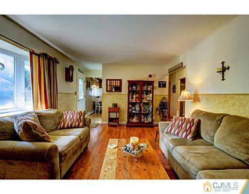 22 Sanders Road Edison, NJ 08817 - Photo 5 of 25 a living room with furniture and a couch