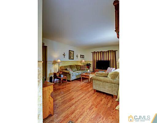 22 Sanders Road Edison, NJ 08817 - Photo 7 of 25 a living room with furniture and a fireplace