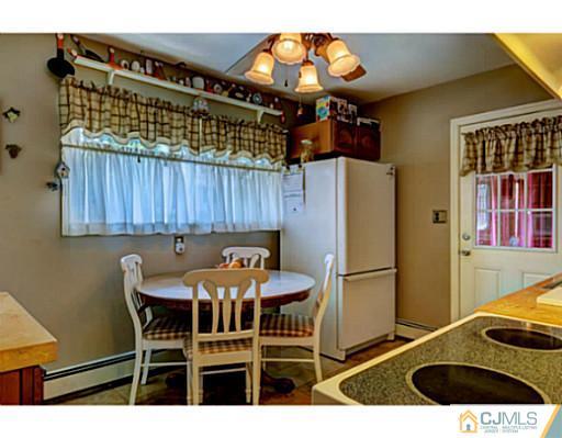 22 Sanders Road Edison, NJ 08817 - Photo 10 of 25 a kitchen with stainless steel appliances granite countertop a refrigerator and a wooden cabinets