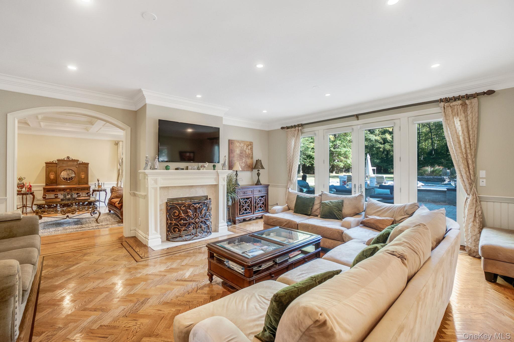 1 Norgate Road Glen Head, NY 11545 - Photo 11 of 42 a living room with furniture a fireplace and a flat screen tv