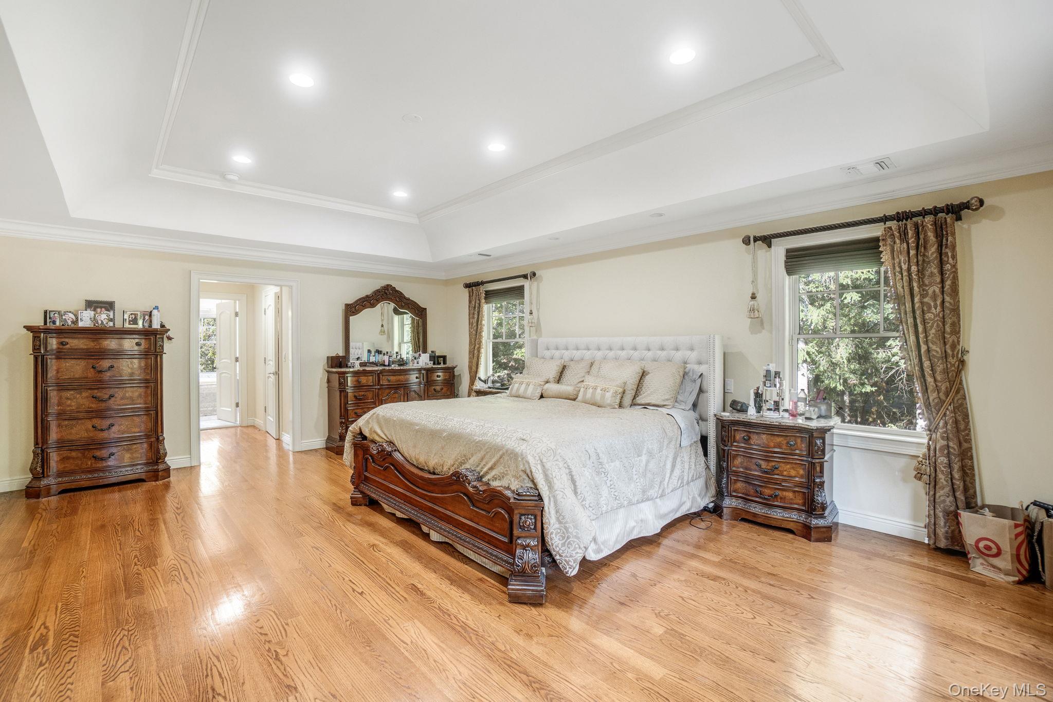 1 Norgate Road Glen Head, NY 11545 - Photo 21 of 42 a spacious bedroom with a bed a dresser and wooden floor