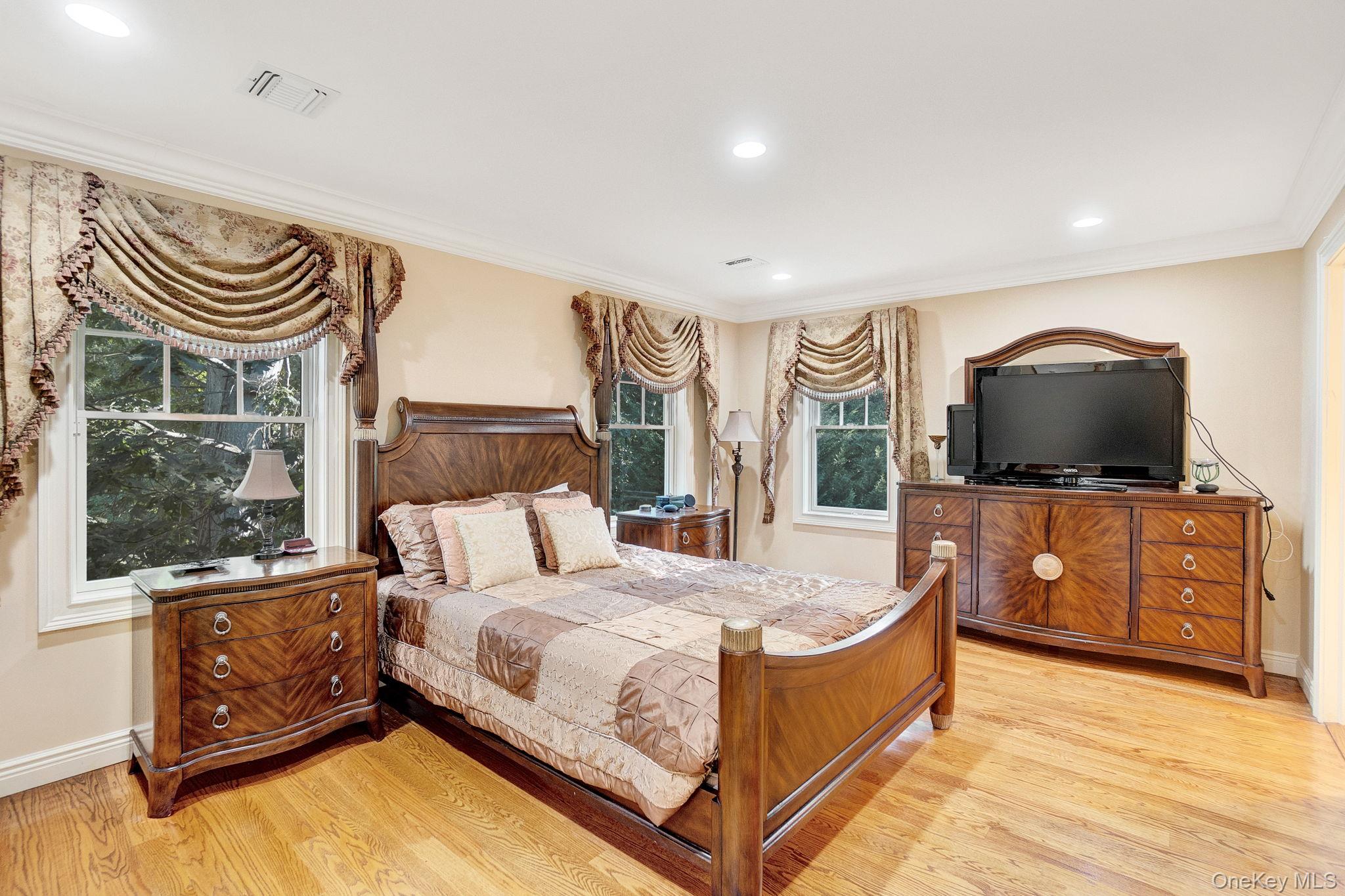 1 Norgate Road Glen Head, NY 11545 - Photo 29 of 42 a spacious bedroom with a bed and a flat screen tv