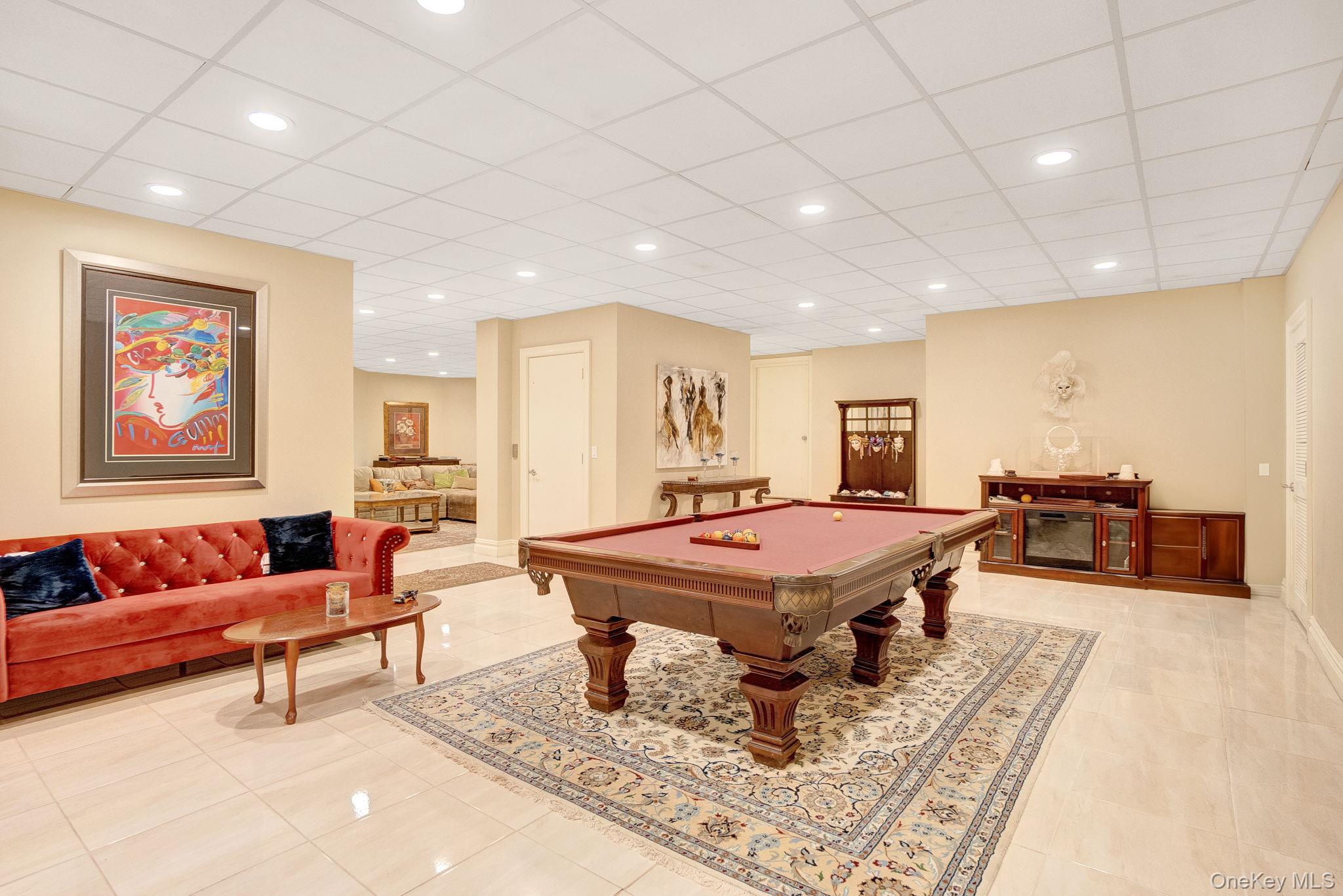 1 Norgate Road Glen Head, NY 11545 - Photo 34 of 42 a living room with furniture a table and a flat screen tv