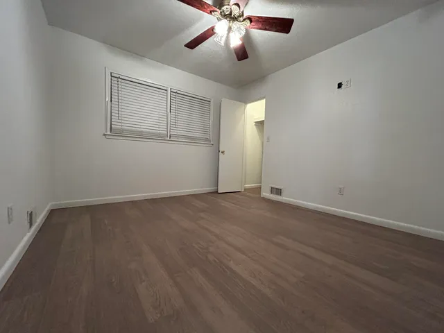 a view of a balcony with furniture and wooden floor
