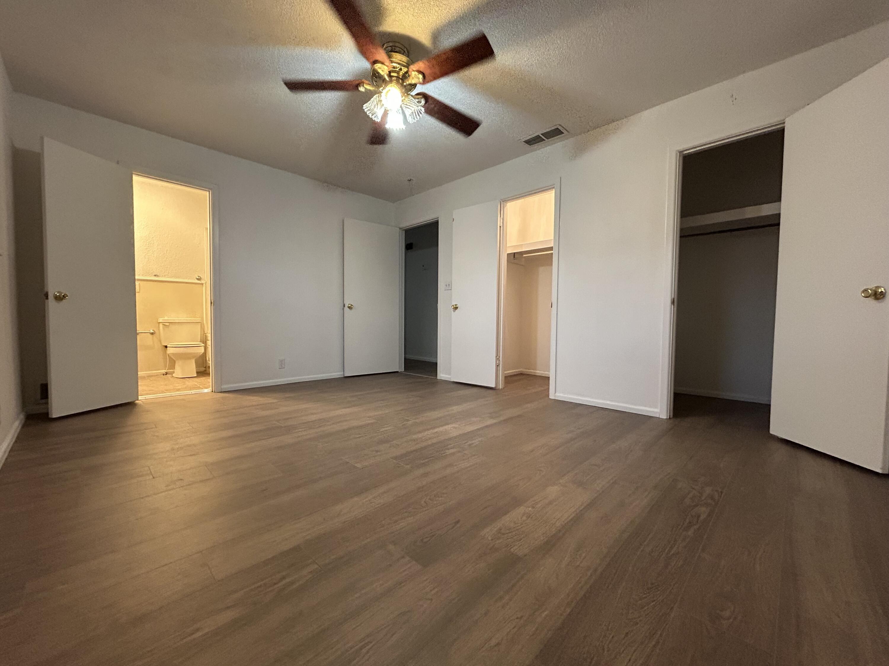 801 North 18th Street Lamesa, TX 79331 - Photo 12 of 15 an empty room with wooden floor and windows