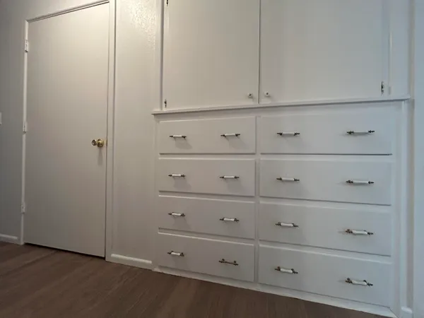 a view of an empty room with a fan