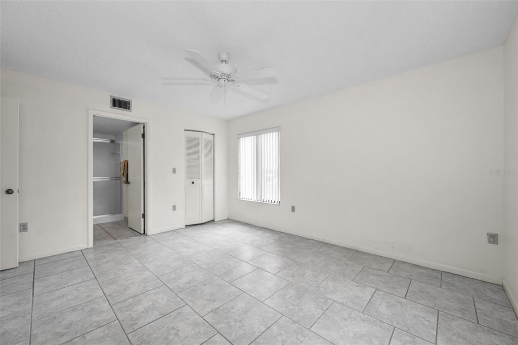 2687 Pine Ridge Way South, Unit B2 Palm Harbor, FL 34684 - Photo 21 of 68 an empty room with fan and windows