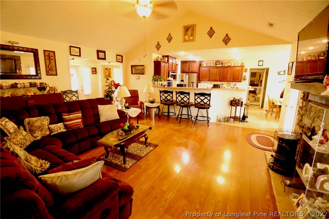 6087 Roebud Road Stedman, NC 28391 - Photo 22 of 31 a living room with furniture and a flat screen tv