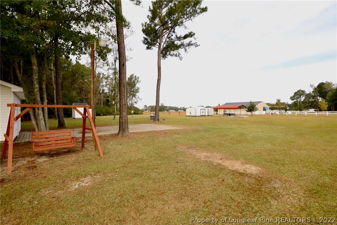 6087 Roebud Road Stedman, NC 28391 - Photo 8 of 31 a park with lots of trees and slides