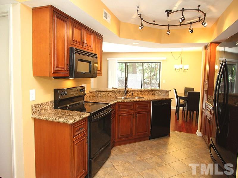 2432 Condor Court, Unit 2432 Raleigh, NC 27615 - Photo 2 of 11 a kitchen with stainless steel appliances granite countertop a stove a sink dishwasher and a refrigerator